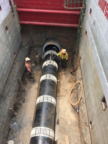 DN900 carrier pipe fitted with kwik-ZIP spacer rings being slip-lined into the jacking pipe from a shored pit