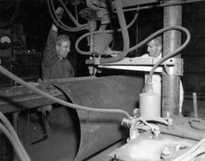 Hume Steel, 1949 - two workers welding a joint on a steel pipe