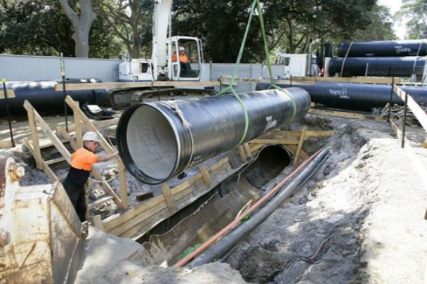 Steel Mains coated pipe being installed on site