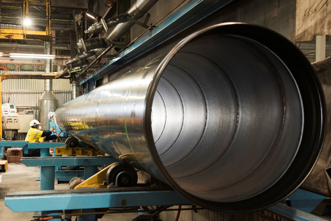 Mild Steel Cement Lined pipe on rollers during manufacture